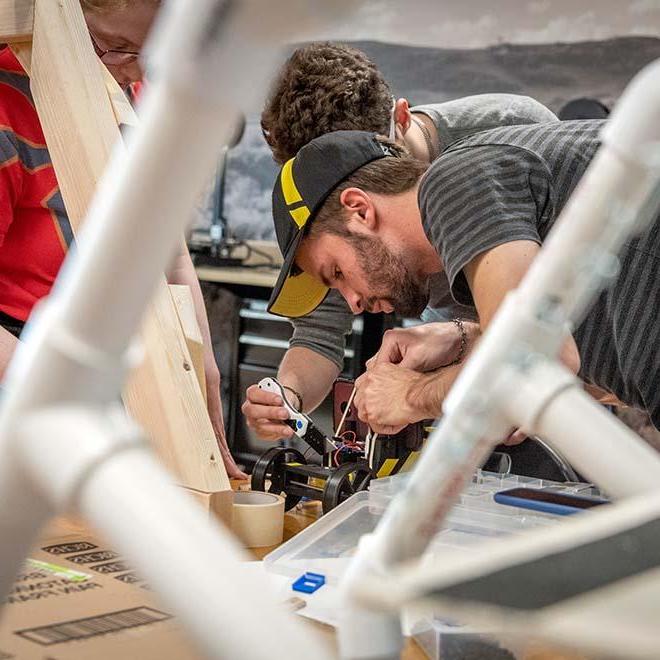 Engineering students working in shop