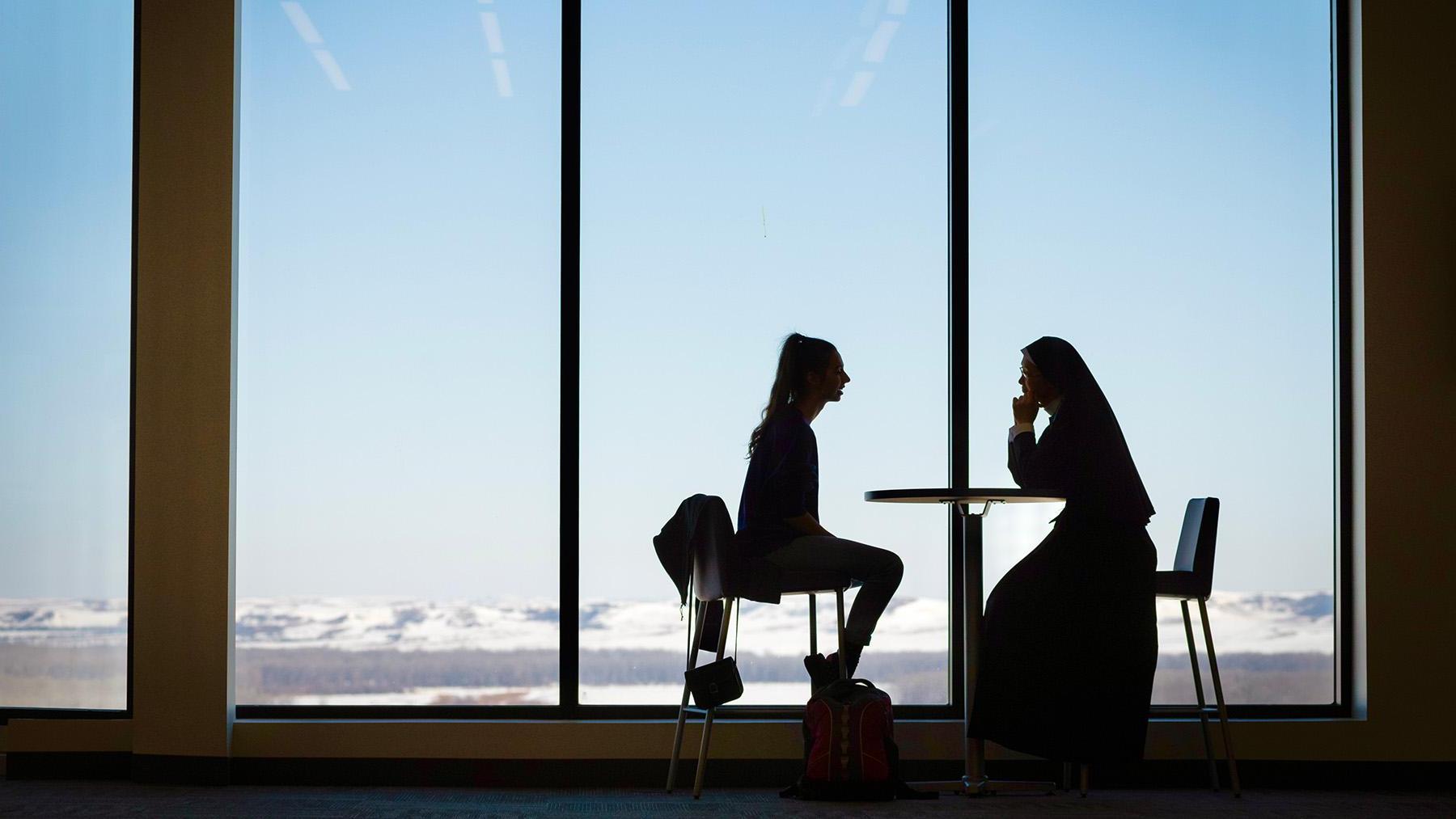 Sister and Student silhouette sitting in Chicks Place